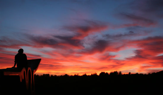 Student looking out at sunset atop the Porter Squiggle.